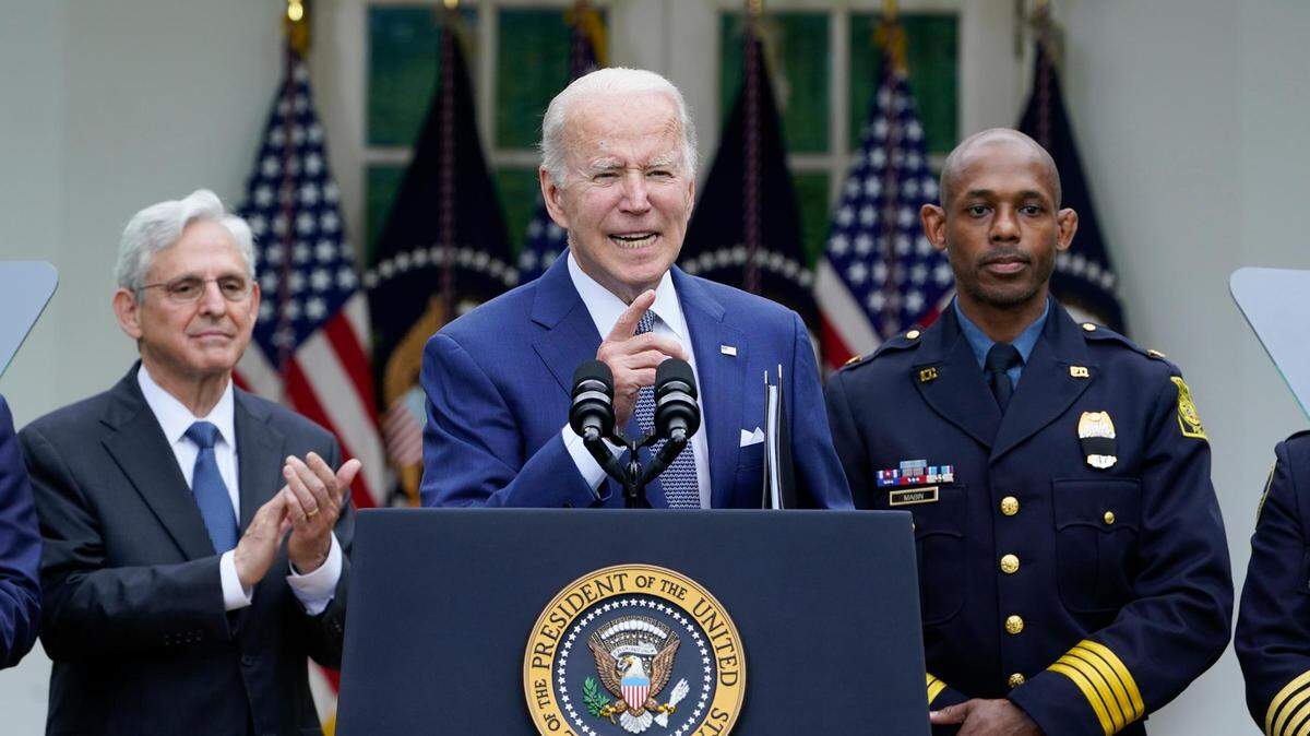 Attorney General Merrick Garland, left, and Kansas City Interim Police Chief Joe Mabin listened as President Joe Biden spoke in the Rose Garden of the White House in May during an event to highlight state and local leaders who are investing American Rescue Plan funding.