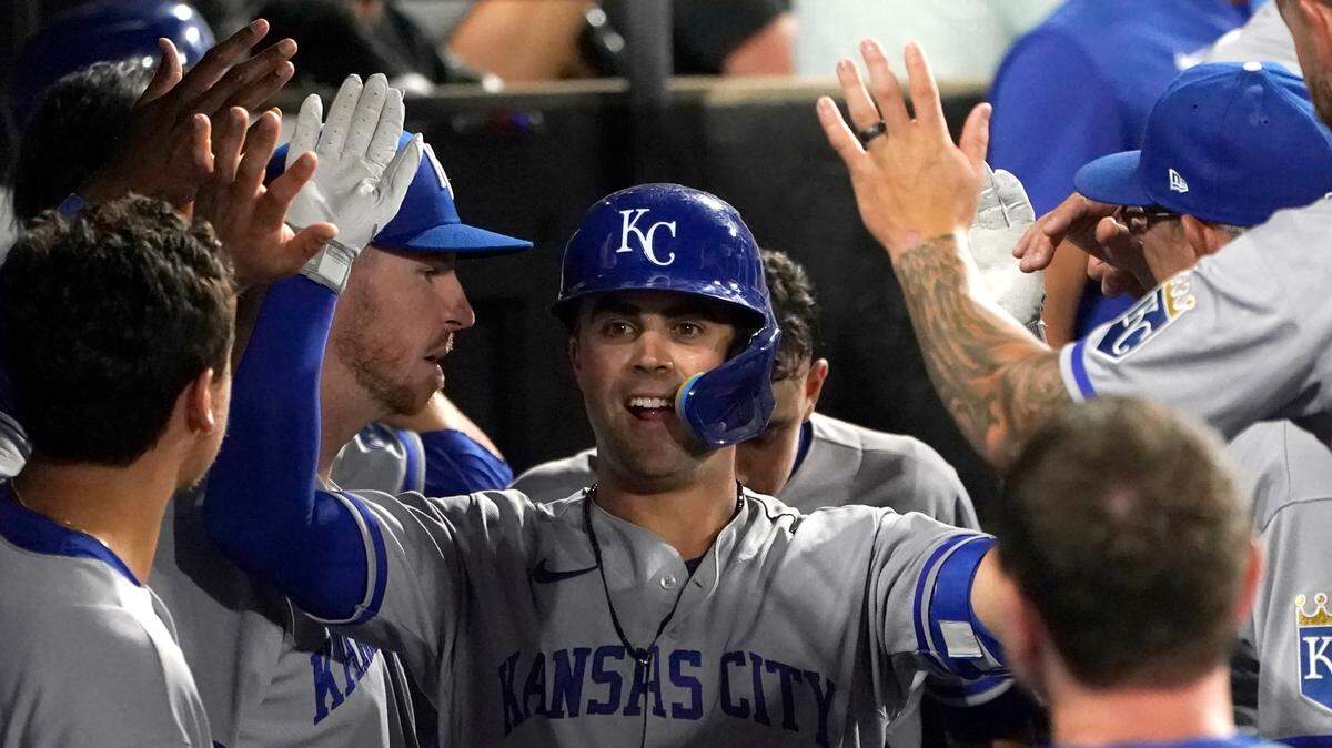 Kansas City Royals’ Whit Merrifield celebrate in the dugout his home run off Chicago White Sox starting pitcher Michael Kopech during the sixth inning of a baseball game Monday, Aug. 1, 2022, in Chicago. (AP Photo/Charles Rex Arbogast)