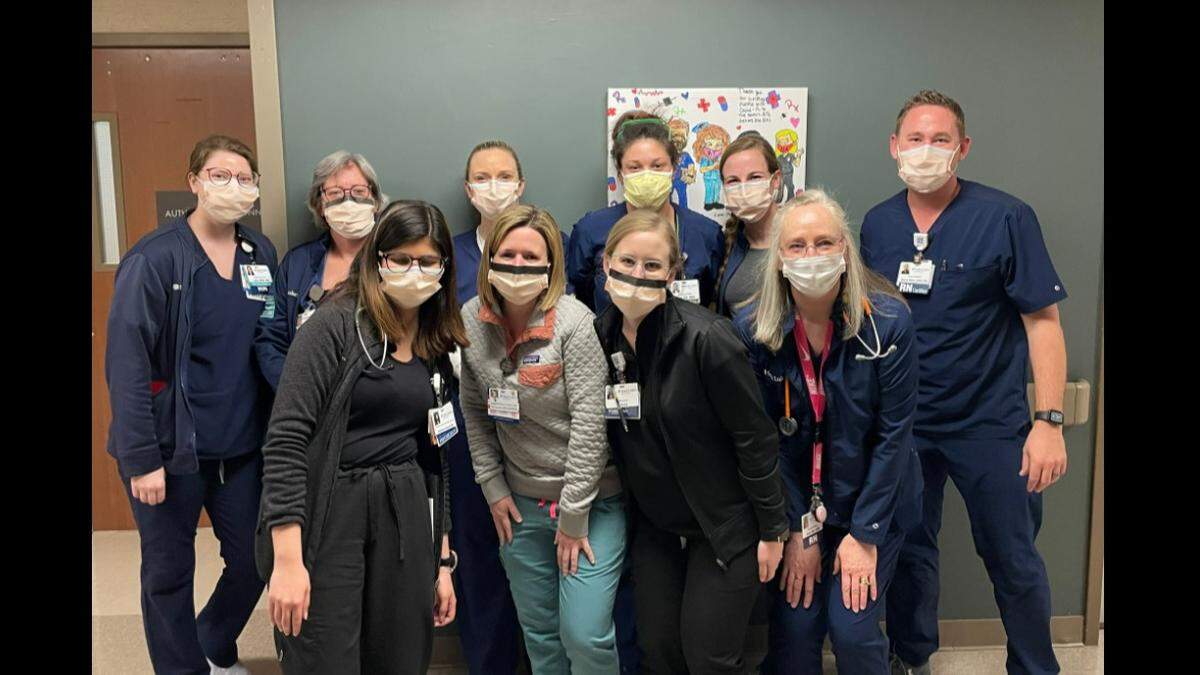 St. Luke’s Hospital of Kansas City staff pose for a picture to celebrate zero COVID patients in the ICU
