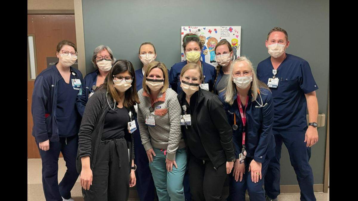 St. Luke’s Hospital of Kansas City staff pose for a picture to celebrate zero COVID patients in the ICU