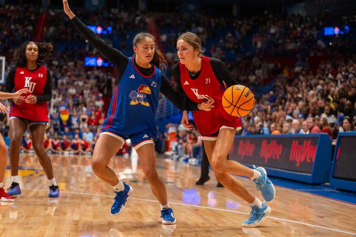 Kansas Jayhawks guard Elle Evans drives past guard Brittany Harshaw during the women's team scrimmage at Late Night in the Phog, on Friday, October 17, 2025, in Lawrence.
