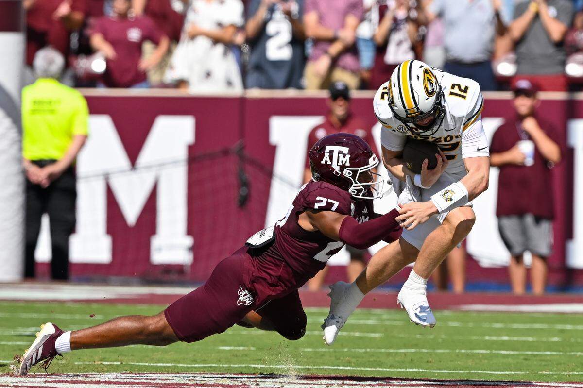 Texas A&M linebacker Daymion Sanford tackles Missouri Tigers quarterback Brady Cook during Saturday’s SEC football game at Kyle Field in College Station, Texas.