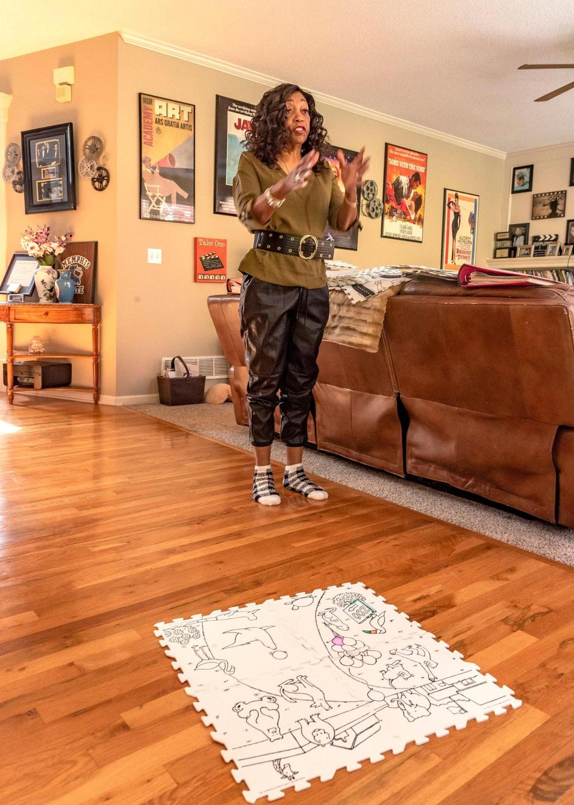 Inventor Vanessa Faller and some of her Color-N-Wash mats. Movie posters on her walls are reminders of her time living in Los Angeles.