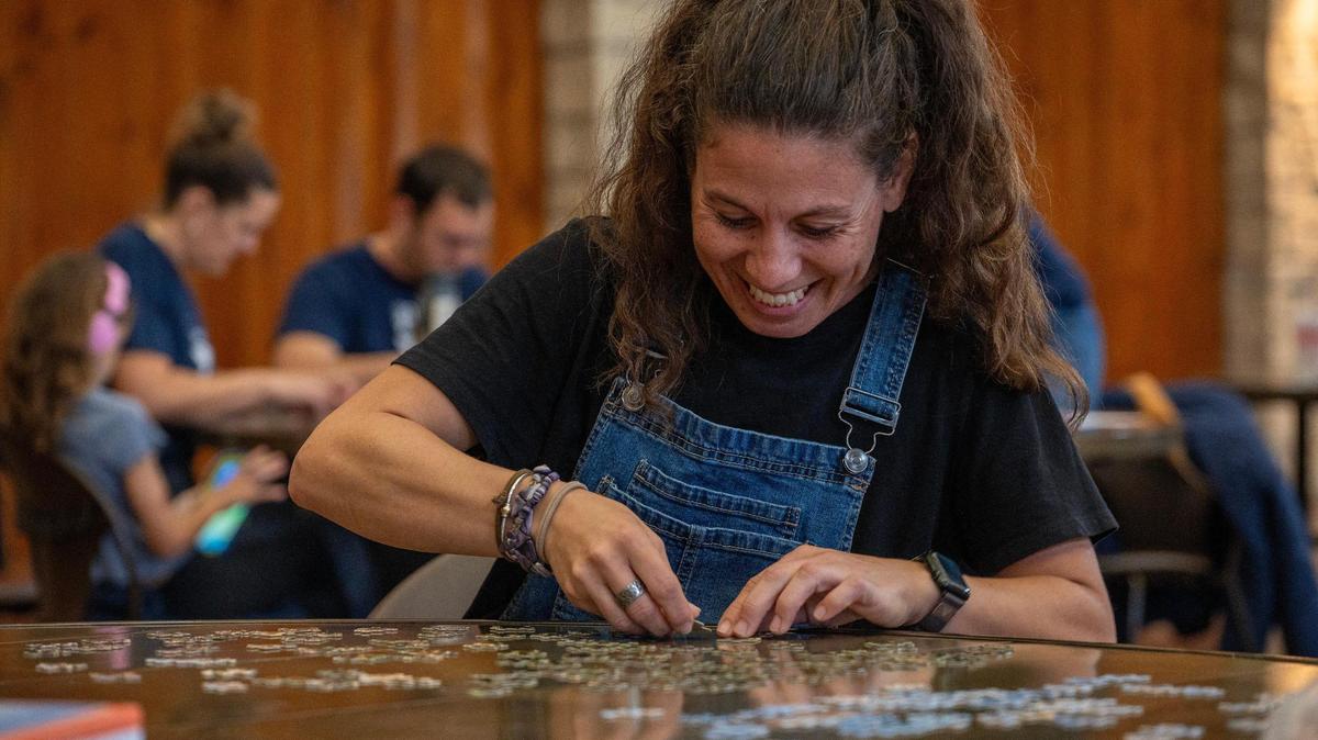 Sandy Dusel works on a 500-piece puzzle with her team, Barely Holding It Together, during the Puzzle Palooza competition at The Lodge at Ironwoods on Sunday, Nov. 3, 2024, in Leawood.