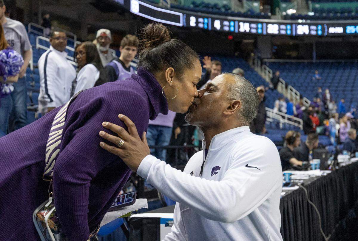 Kansas State coach Jerome Tang kisses his wife Careylyen after picking up his first NCAA Tournament victory as a head coach after defeating Montana State in Greensboro, NC on Friday night.
