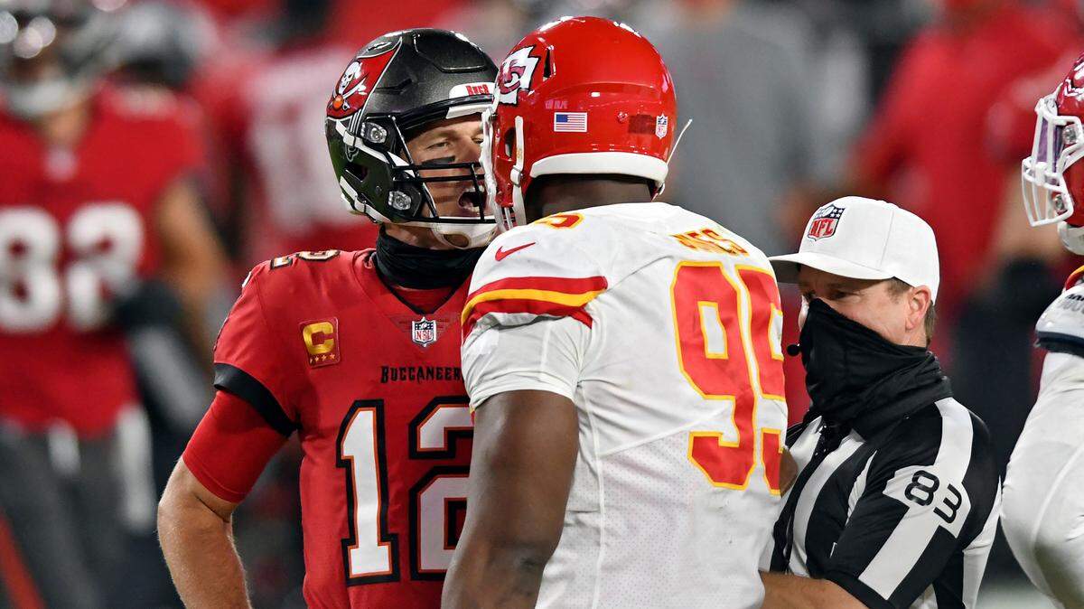 Tampa Bay Buccaneers quarterback Tom Brady (12) exchanges words with Kansas City Chiefs defensive tackle Chris Jones (95) as referee Shawn  Hochuli (83) tries to separate the two during the second half of an NFL football game Sunday, Nov. 29, 2020, in Tampa, Fla. (AP Photo/Jason Behnken)