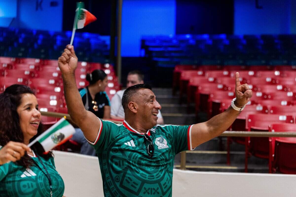Fernando Ramirez holds up their Mexican Flag and gestures a number one with his hand after Team Mexico's first goal at the KCK Mexico v. South Africa Watch Party hosts at Memorial Hall on Thursday, June 11, 2026.