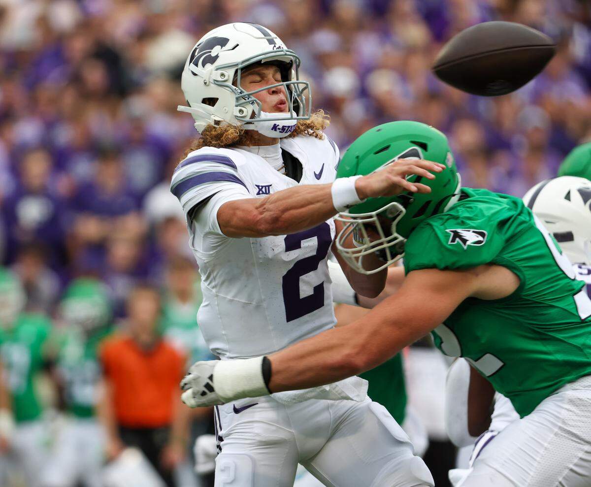 Kansas State Wildcats quarterback Avery Johnson (2) is hit by North Dakota Fighting Hawks edge Grady Kentch (92) as he throws the ball during the first quarter at Bill Snyder Family Football Stadium on Aug. 30, 2025.