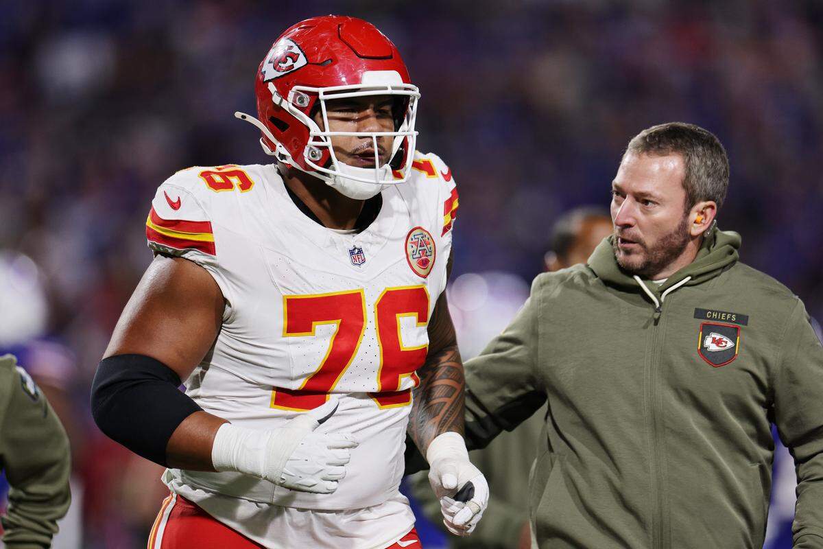 Kansas City Chiefs offensive lineman Kingsley Suamataia is accompanied off the field by a member of the KC training staff during an NFL Week 9 game against the Buffalo Bills at Highmark Stadium in Orchard Park, New York, on Sunday, Nov. 2, 2025.