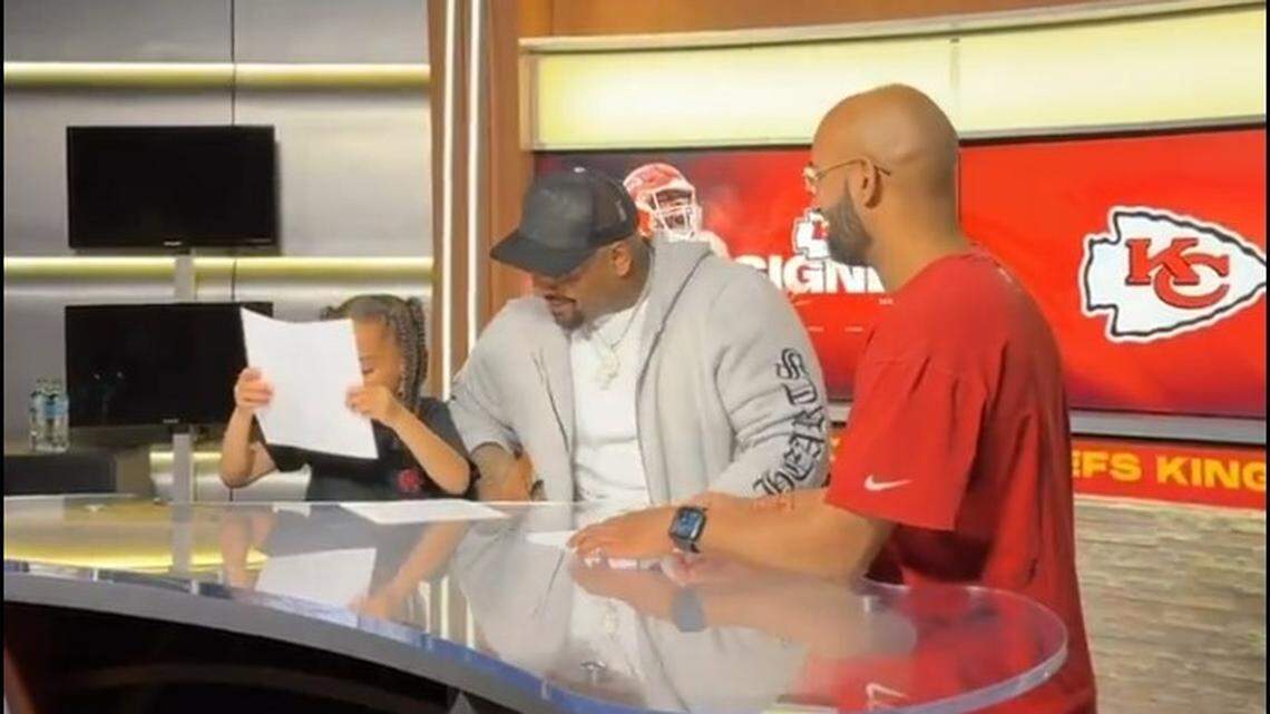 Chiefs defensive lineman Mike Pennel had his young son peruse his contract before signing.