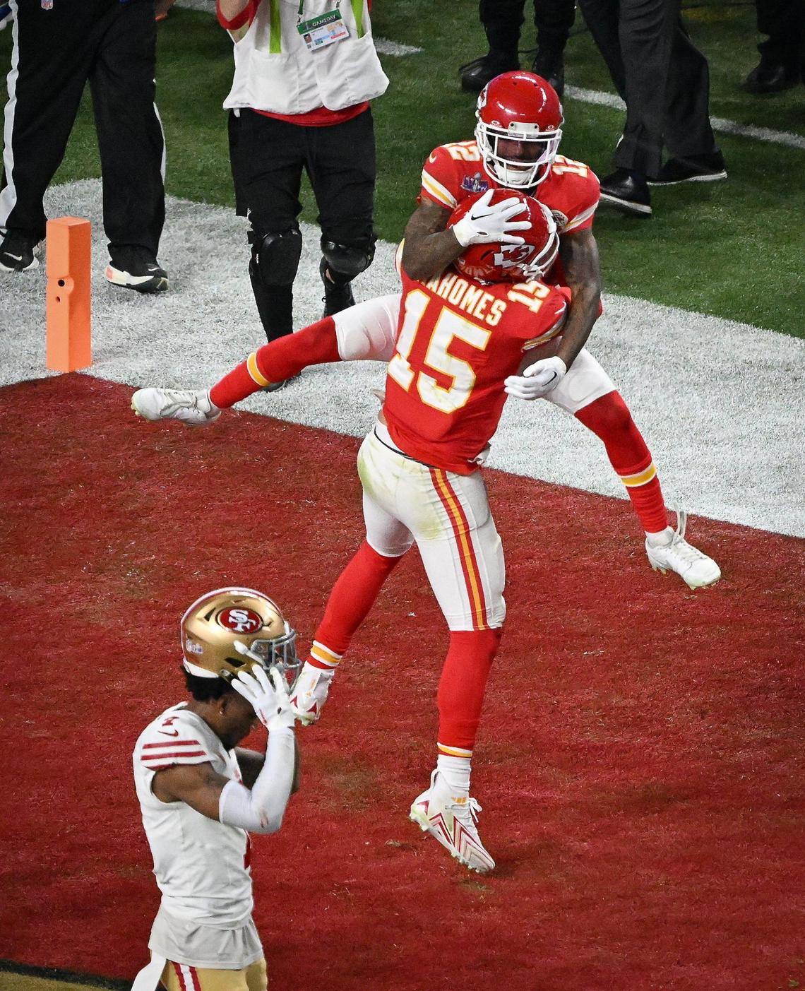 Kansas City Chiefs’ Mecole Hardman Jr. (12) jumps into the arms of quarterback Patrick Mahomes (15) after catching the game-winning touchdown reception to defeat the San Francisco 49ers in overtime in Super Bowl LVIII, Sunday, Feb. 11, 2024, in Las Vegas.