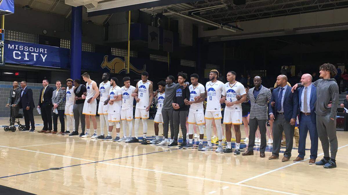 UMKC basketball players and coaches stand for the alma mater after the Kangaroos’ victory over Chicago State at Swinney Recreation Center on Jan. 5, 2019.