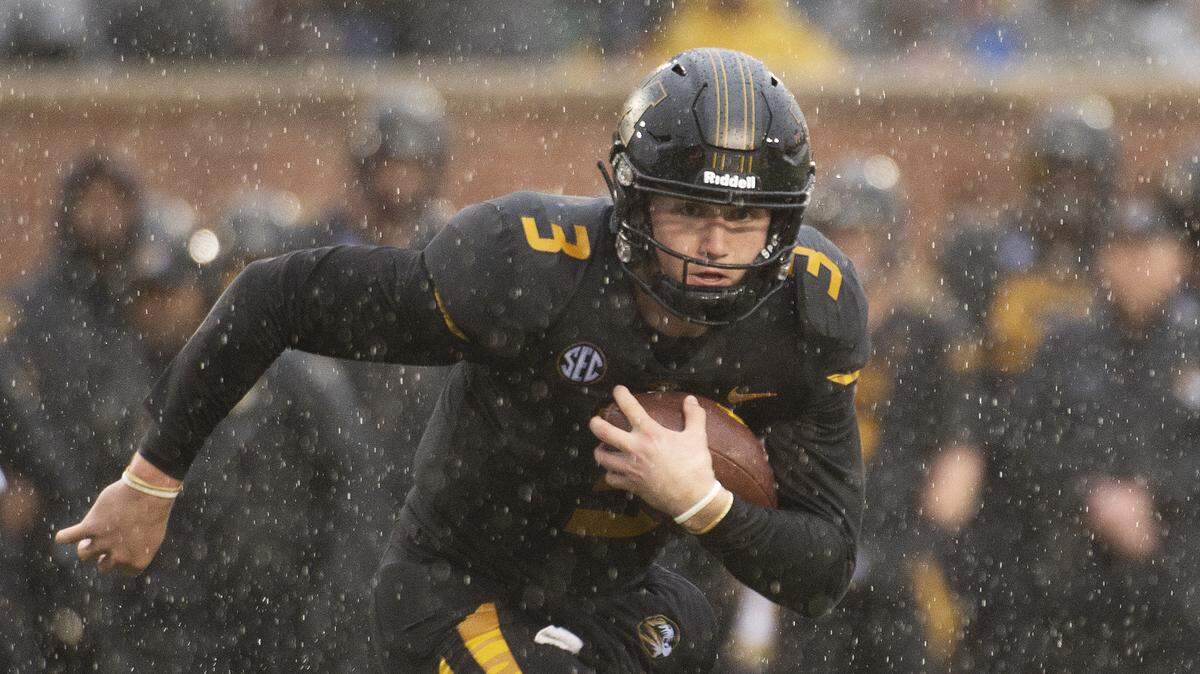 Missouri quarterback Drew Lock ran with the ball during the first half of the game on Friday in Columbia against Arkansas.
