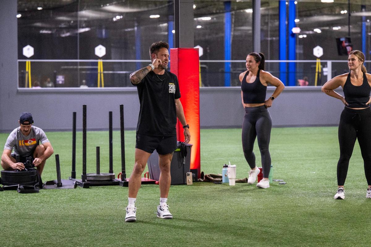 Bobby Stroupe guides participants through a warm-up during a training session at Homefield Kansas City.