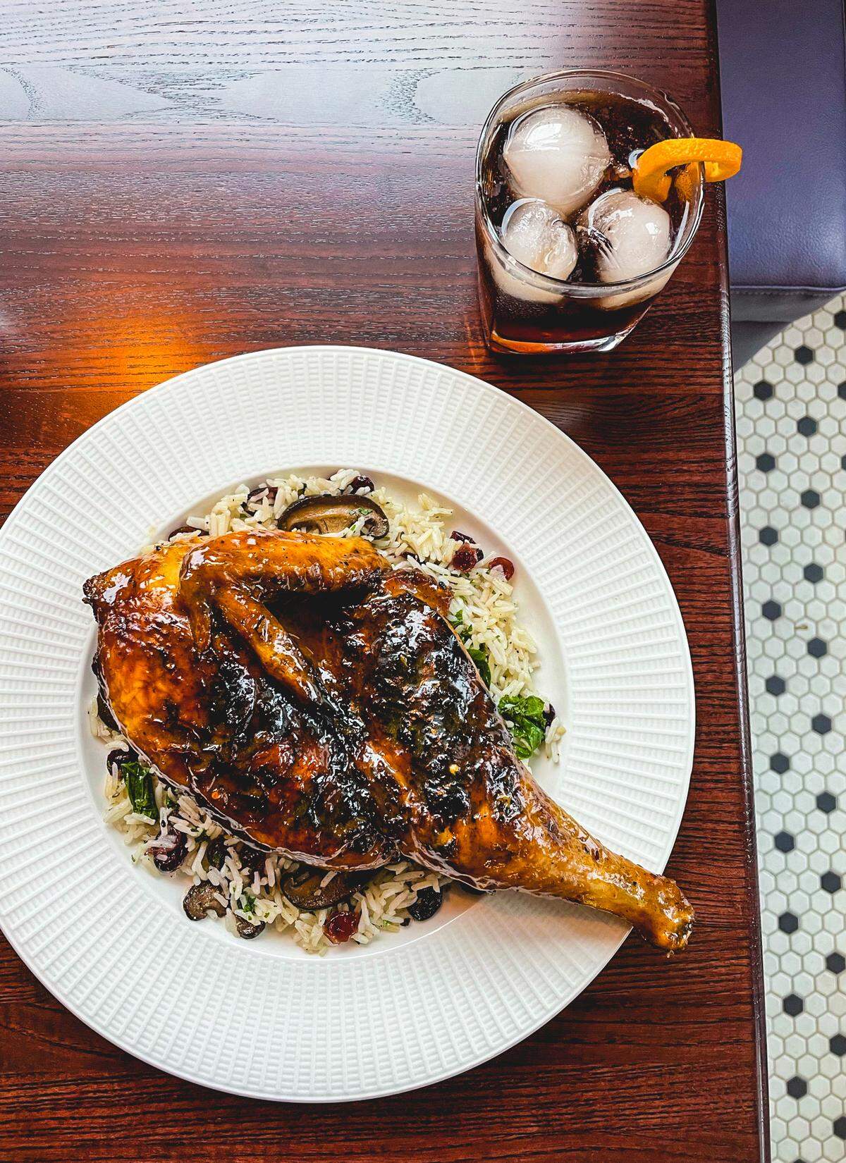 The Peacock’s Peri Peri chicken includes peri spiced half chicken, dirty basmati rice, shiitakes, cranberry, charred greens and chamoy butter.