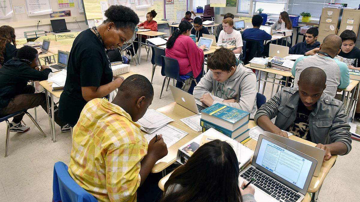 Denairian Johnson, an English Language Arts teacher at Eastgate Middle School, moves freely around her classroom to answer questions and give specific instruction to individual students. She helped Keiante Dixon, a seventh grader, during a recent session at the school.