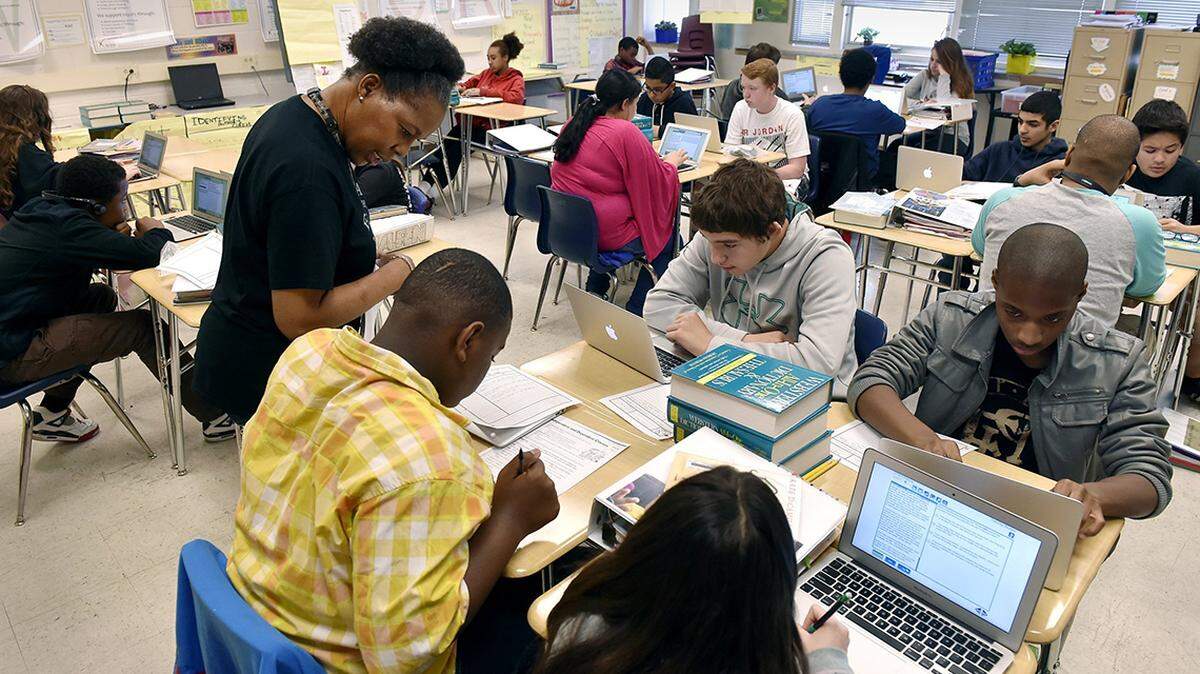 Denairian Johnson, an English Language Arts teacher at Eastgate Middle School, moves freely around her classroom to answer questions and give specific instruction to individual students. She helped Keiante Dixon, a seventh grader, during a session at the school last year.