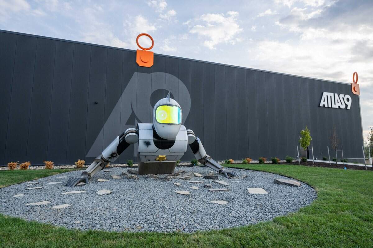 A robot coming out of the ground is outside to meet visitors to Atlas 9, on Wednesday, Sep. 3, 2025, in Kansas City, Kansas. The narrative-driven immersive art experience featuring interactive games, videos, and AI-powered experiences, all housed inside a retro movie theater.