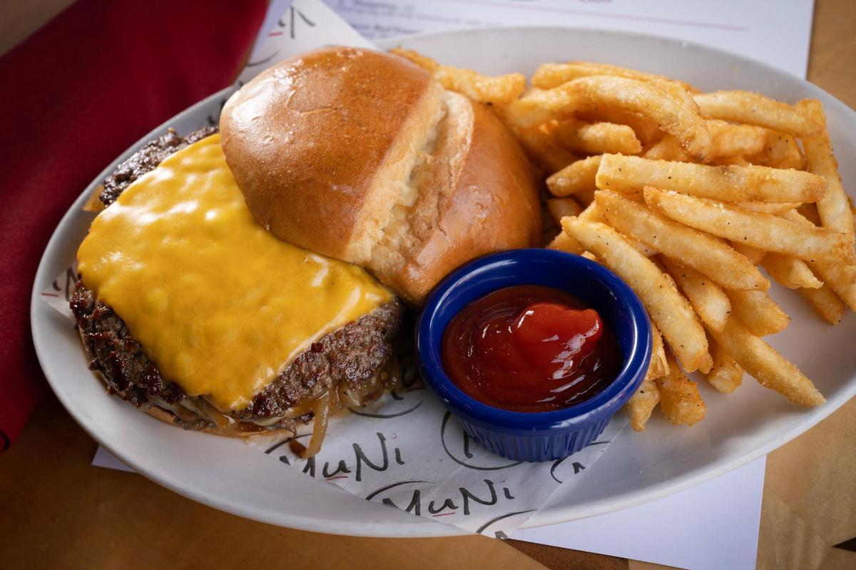 The Smash Dat Muni includes two quarter pound beef smash patties, chile jam caramelized onions, American and provolone cheese, spicy mayo on a brioche bun with fries, $16.