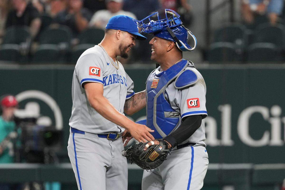 Kansas City Royals relief pitcher Steven Cruz (64) and catcher Salvador Perez (13) celebrate their teams 6-1 win over the Texas Rangers following the ninth inning at Globe Life Field on Jun 17, 2025 in Arlington, Texas, USA.