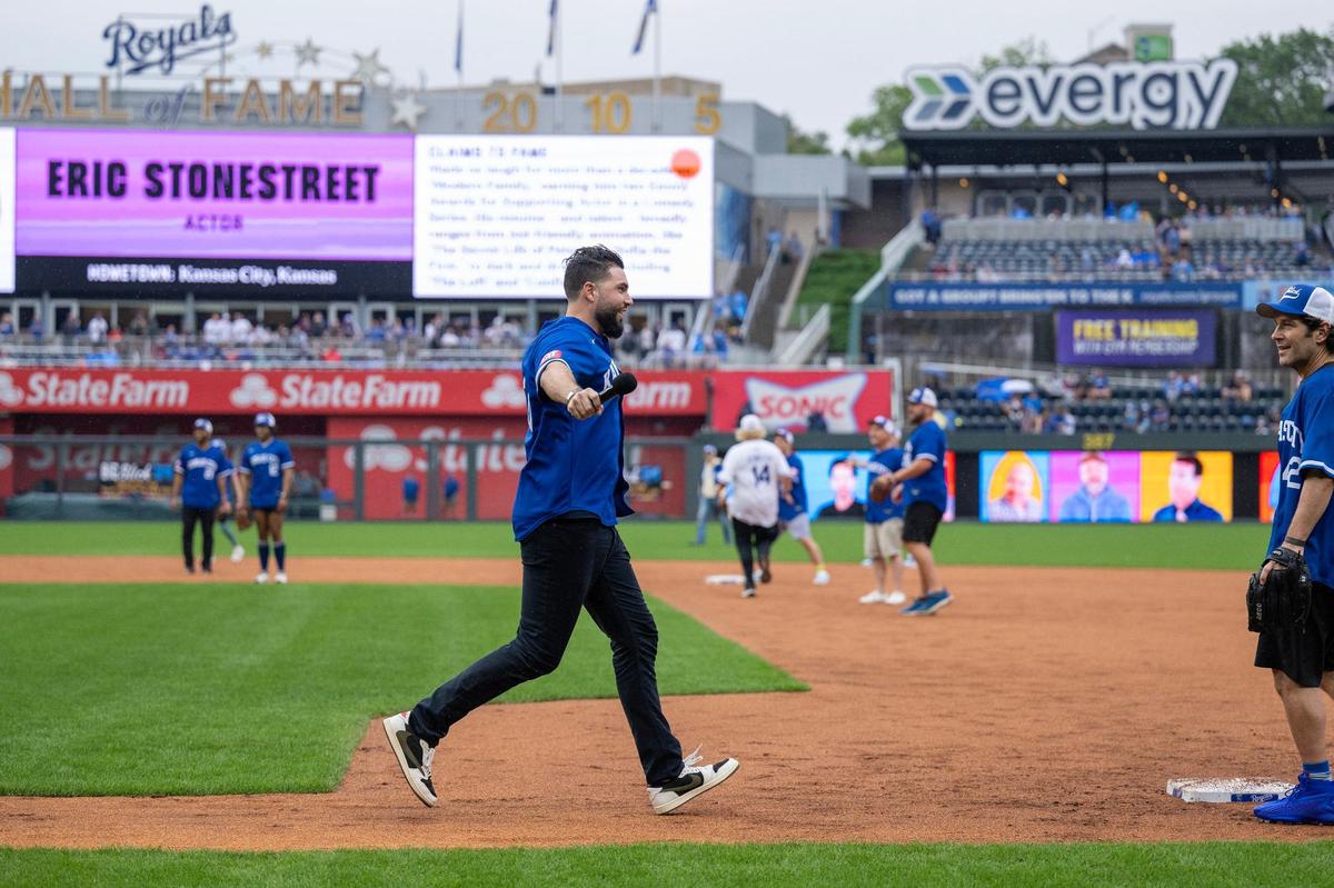 Kansas City Royals first baseman Eric Hosmer runs to first base while actor Eric Stonestreet bats during the Big Slick celebrity softball game at Kauffman Stadium on Friday, May 31, 2024, in Kansas City.