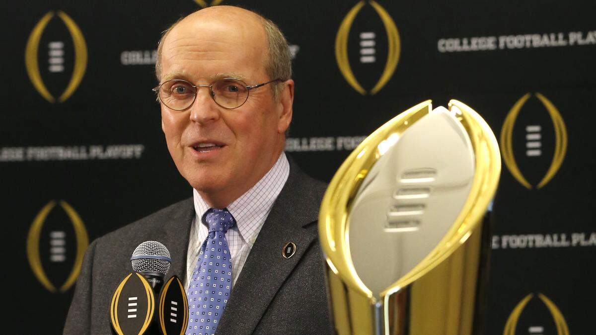 College Football Playoff Executive Director Bill Hancock and new University of Kansas athletic director Jeff Long have 25 years of shared history dating back to their days at Michigan.