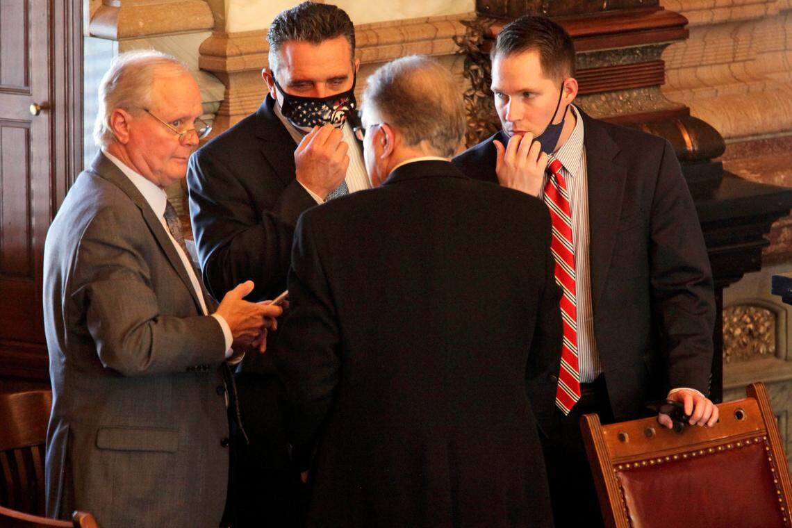 ‘Clockwise from the far left, Senate Majority Leader Gene Suellentrop, R-Wichita; Senate President Ty Masterson, R-Andover; Chase Blasi, Masterson’s operations chief, and Sen. Mike Thompson, R-Shawnee, conferring in Topeka in early March.