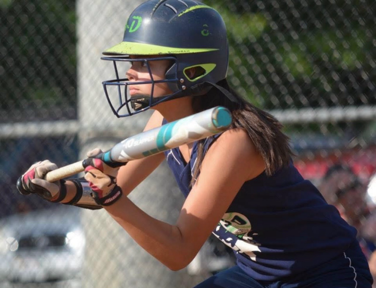 Softball player Lexi Hastings, at age 11, squares up to bunt.