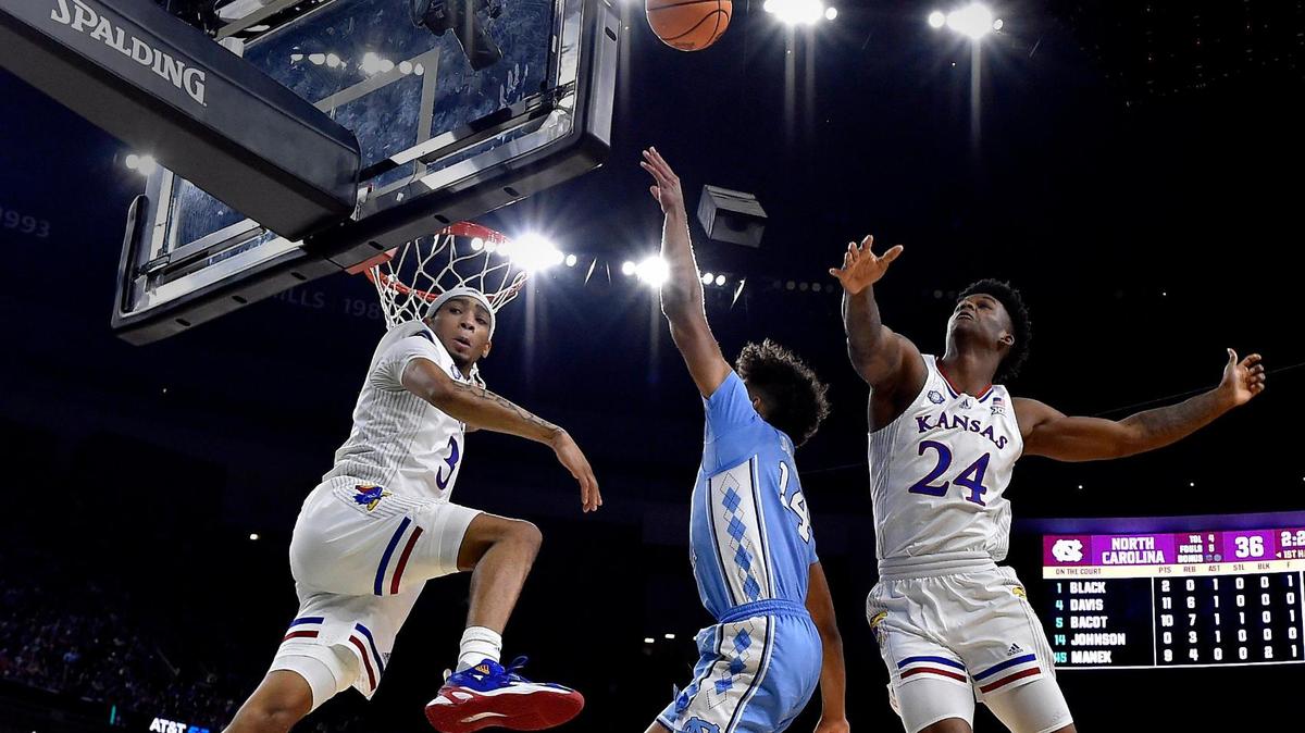 KU’s Dajuan Harris, left, and KJ Adams swat back a shot by UNC’s Puff Johnson during the first half of the 2022 NCAA men’s basketball championship game at the Superdome in New Orleans. KU beat North Carolina, 72-69.