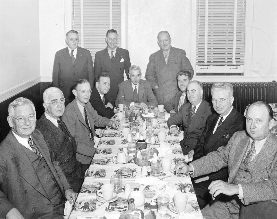 Mayor Kemp (seated center) having lunch with city council members in 1946.