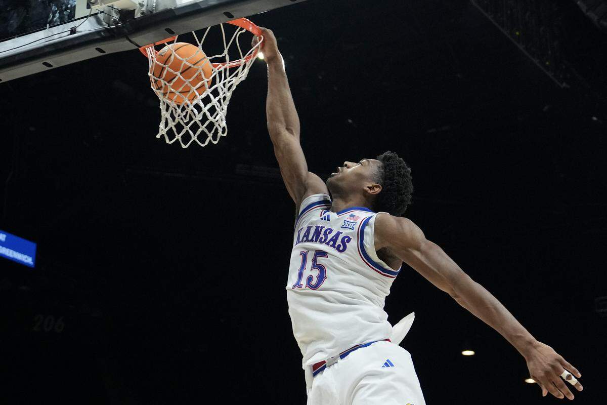 Bryson Tiller #15 of the Kansas Jayhawks dunks the ball against the Notre Dame Fighting Irish in the first half of their game during the Players Era Championship basketball tournament at Grand Garden Arena on November 24, 2025 in Las Vegas.