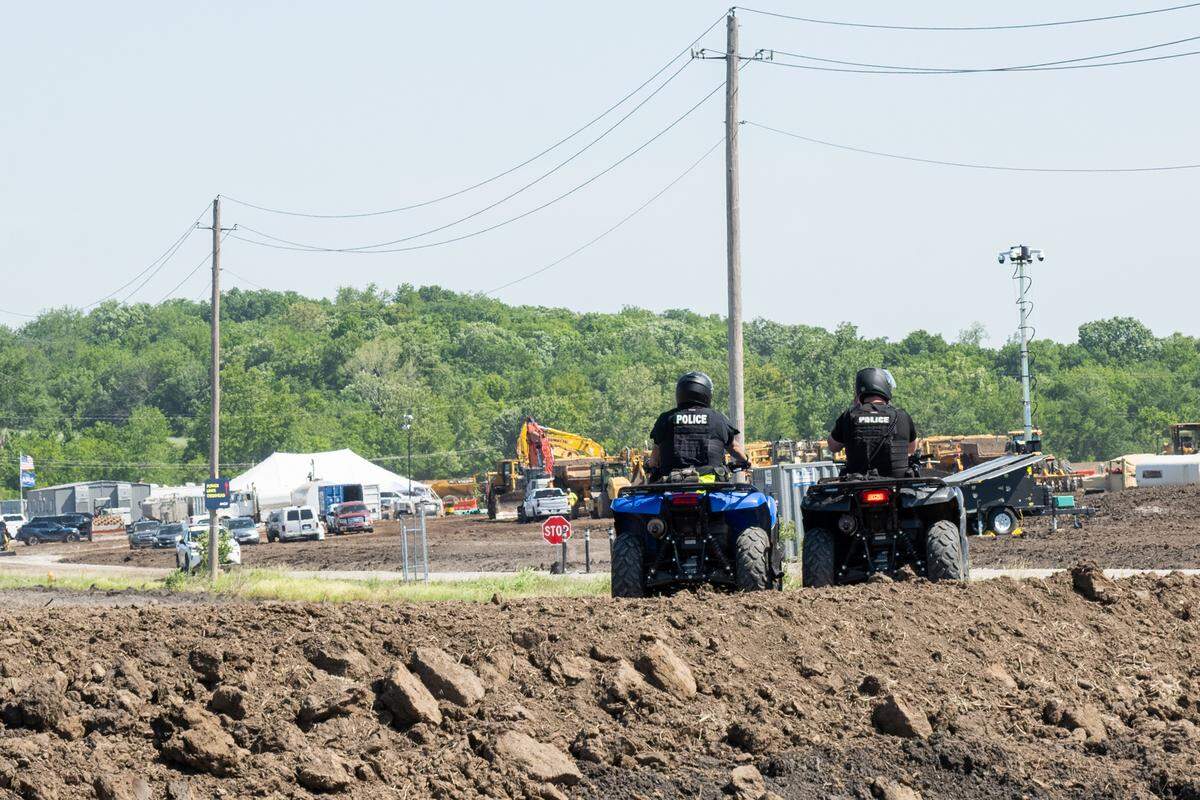 Police on ATV’s sit at the entrance of a groundbreaking ceremony for Nebius, a future AI data center being built in Independence, on Tuesday, May 12, 2026.