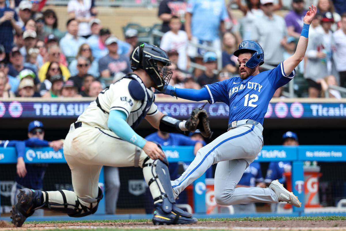 Kansas City Royals left fielder Nick Loftin (12) scores the go ahead run on a double hit third baseman Maikel Garcia (11) during the tenth inning against the Minnesota Twins at Target Field on May 25, 2025 in Minneapolis, Minnesota, USA.