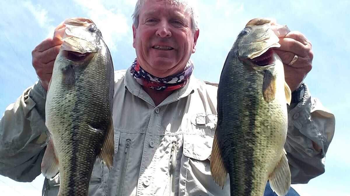 Angler Jeff Blystone shows off two great bass from Prairie Lee Lake in Lee's Summit.