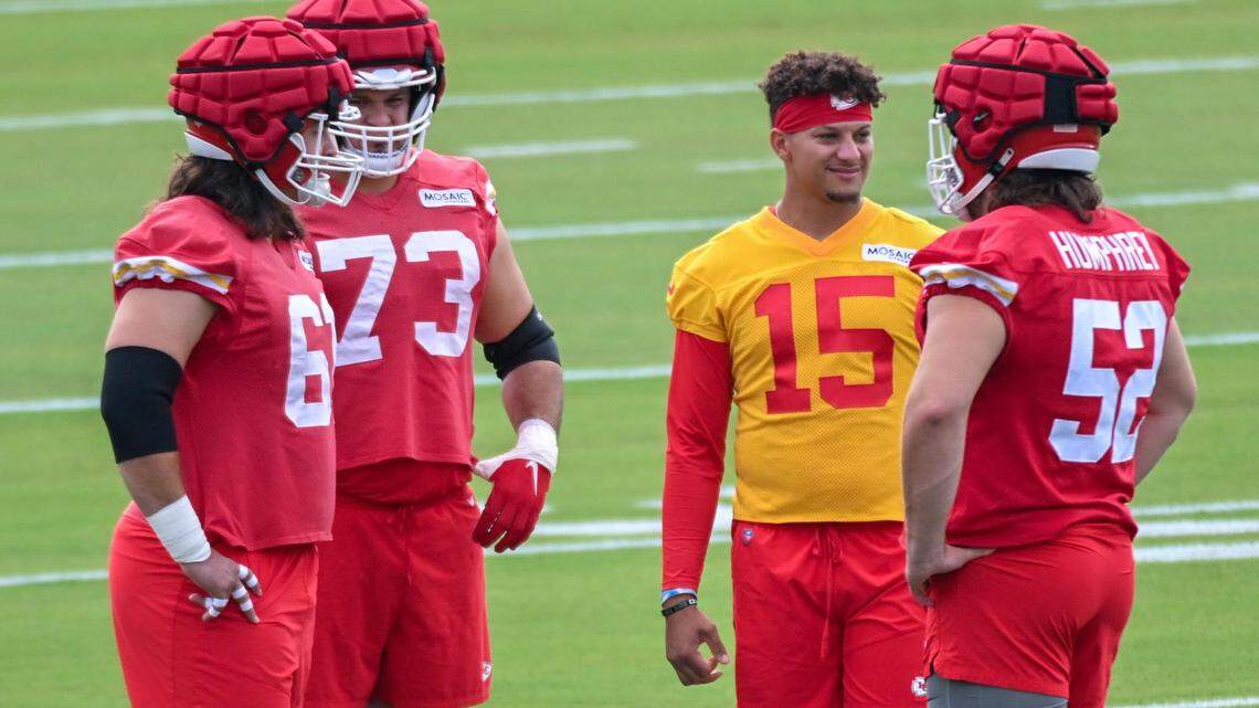 Members of the Chiefs including enter Austin Reiter (61), guard Nick Allegretti (73), offensive lineman Creed Humphrey (52), talked to quarterback Patrick Mahomes (15) while wearing Guardian Caps during training camp on Wednesday, July 27, 2022 at Missouri Western State University, in St. Joseph, Missouri.