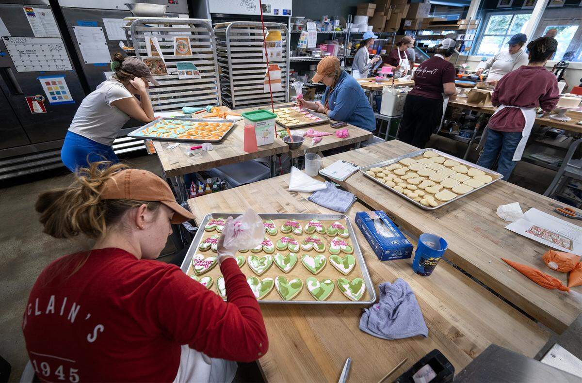 It was all hands on deck at McClain's Bakery in Waldo, where Itty Manville, left, and other decorated Chappell Roan-themed cookies and cakes on Thursday, Oct. 2, 2025. Local bakeries are seeing a significant demand for themed cookies to celebrate pop stars Taylor Swift and Chappell Roan.