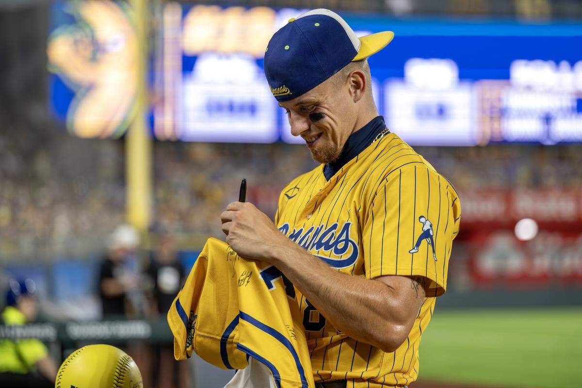 Savannah Bananas pitcher Noah Niznik (88) signs autographs during a Banana Ball game against the Indianapolis Clowns at Kauffman Stadium Saturday, May 30, 2026, in Kansas City.