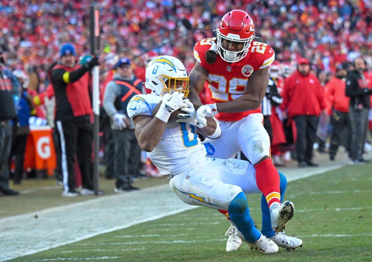 Los Angeles Chargers linebacker Daiyan Henley (0) intercepts a pass from Kansas City Chiefs quarterback Patrick Mahomes (15) in the second half at GEHA Field at Arrowhead Stadium on Sunday, Dec. 14, 2025.