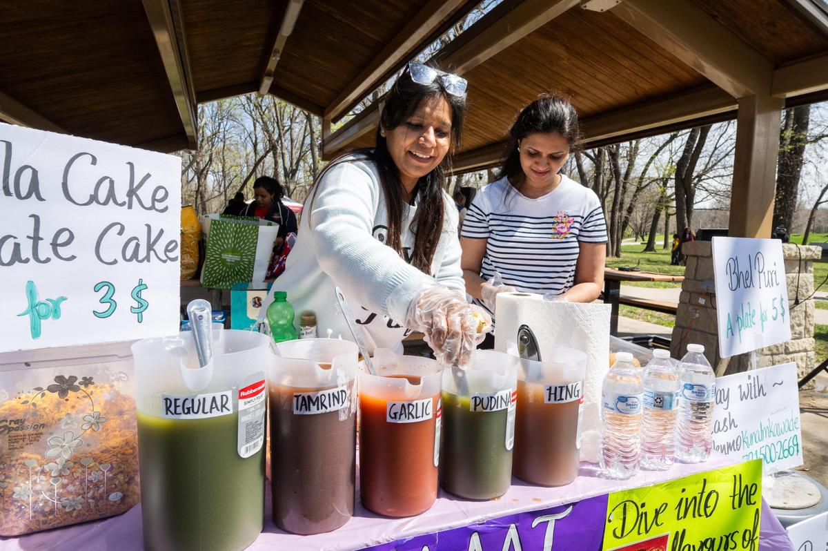 A street food vendor serves up an Indian street food named pani puri at a Holi Festival of Colors in Overland Park on Sunday.