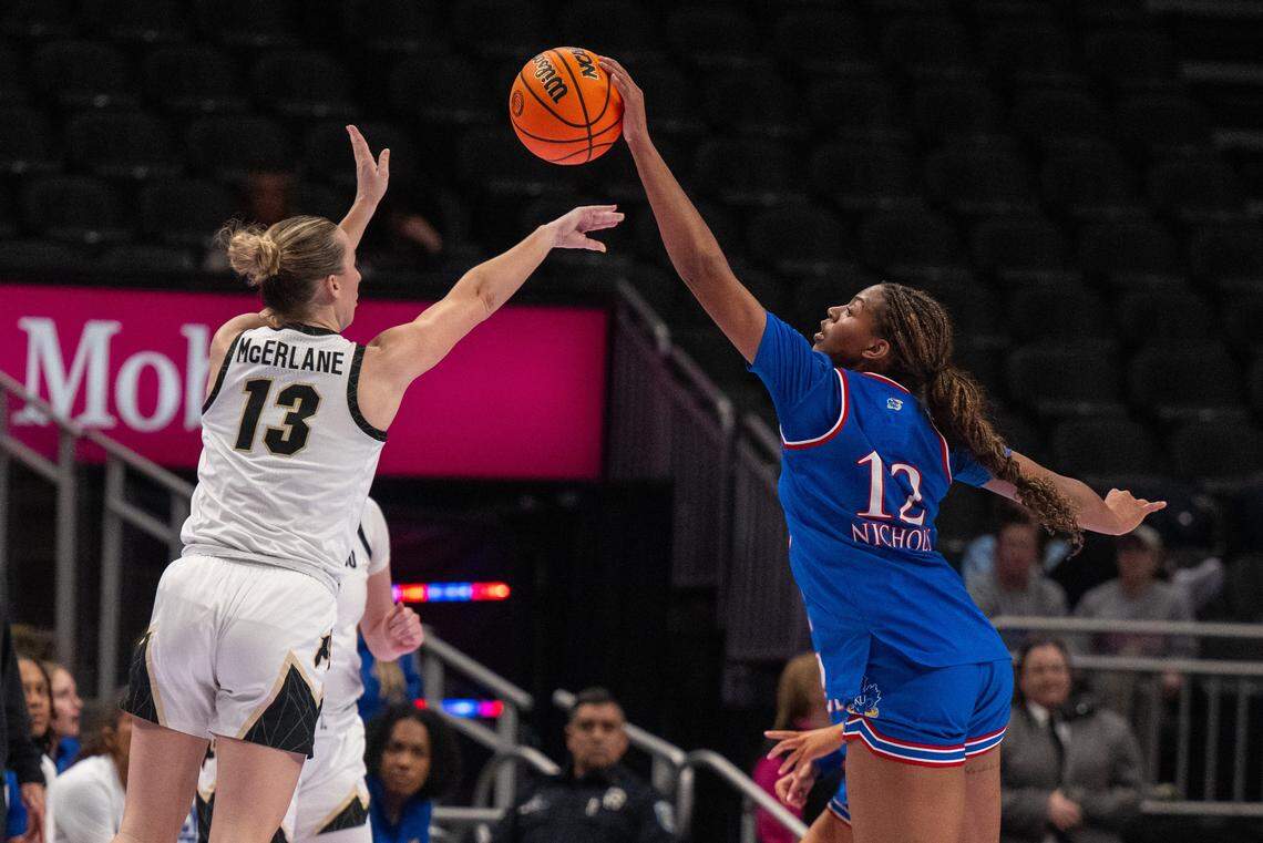 Kansas Jayhawks guard S'Mya Nichols (12) blocks Colorado guard Maeve McErlane’s shot in the first half of KU’s second-round game at the Big 12 Women's Basketball Tournament on Thursday, March 5, 2026, at T-Mobile Center in Kansas City.