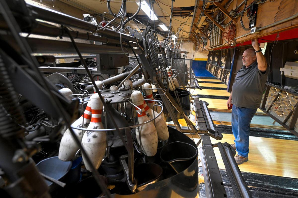 Ron Weller has been a mechanic at St. John Catholic Club’s bowling alley for the past 45 years. He keeps the lanes oiled and the vintage 1965 pinsetter machines operating smoothly.