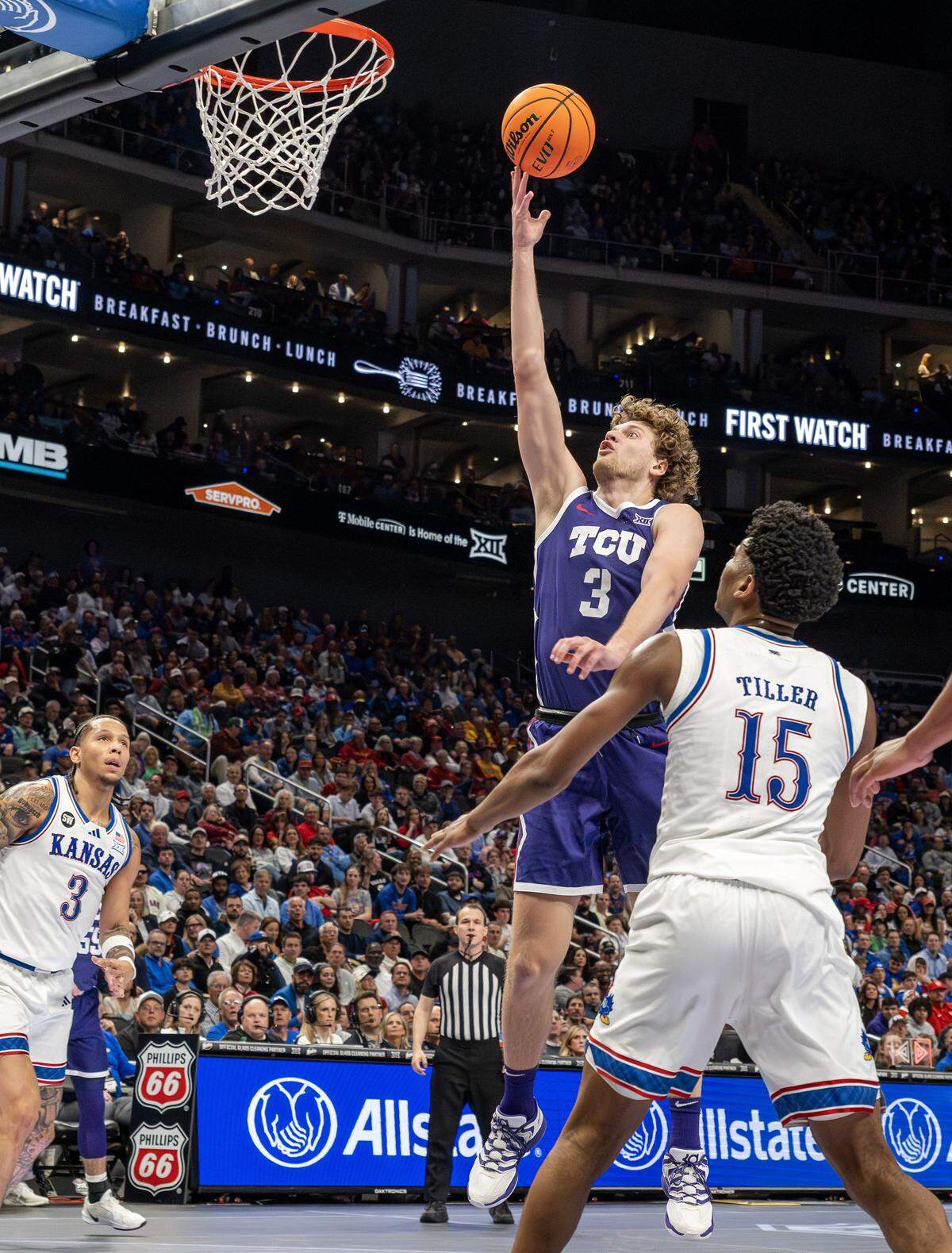 Texas Christian University Horned Frogs guard Liutauras Lelevicius (3) makes a layup during the first half of a Big 12 Men's Basketball Tournament game against the Kansas Jayhawks at T-Mobile Center on Thursday, March 12, 2026, in Kansas City.