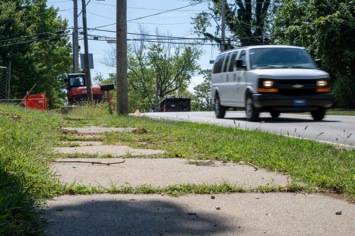 Cracked and worn sidewalks are seen along North Cleveland Avenue near the Chaumiere neighborhood on Monday, Aug. 26, 2024, in Kansas City.