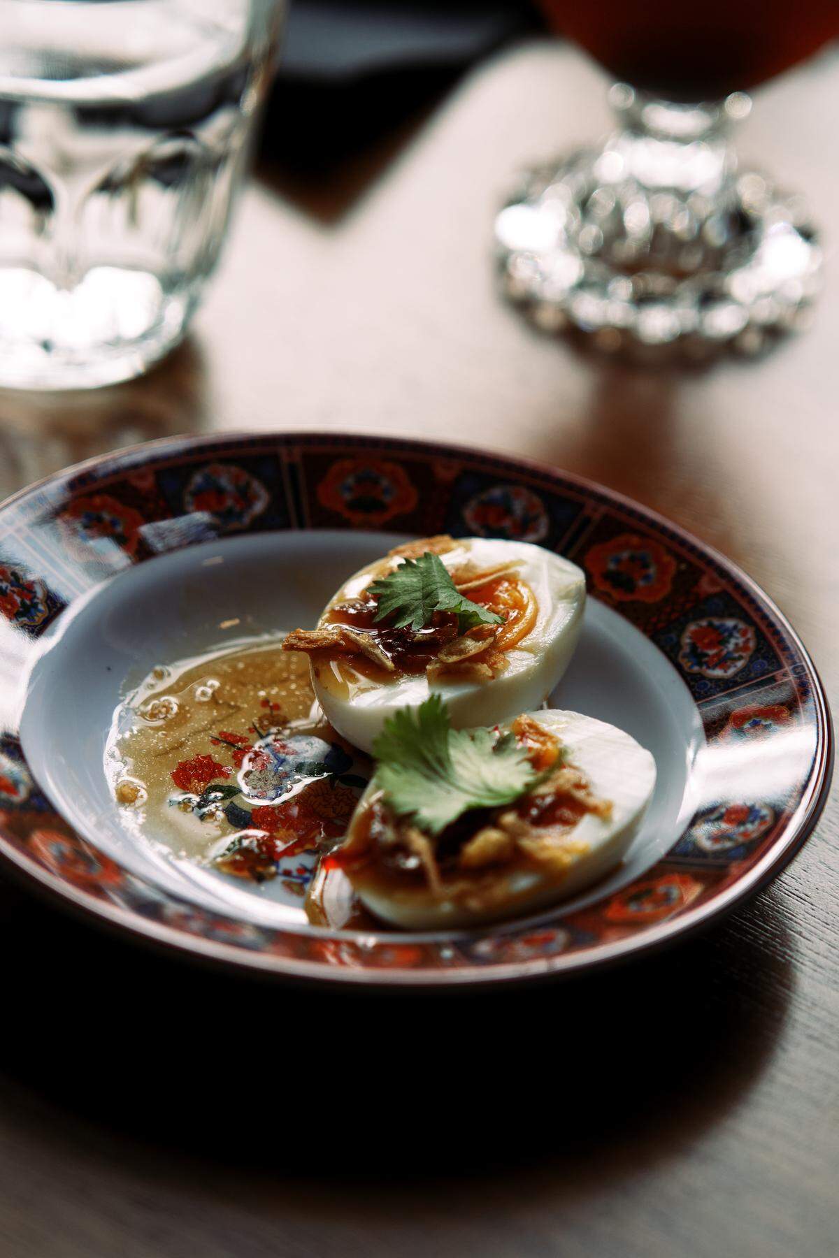 Bar food includes Thai-inspired deviled eggs topped with tamarind, fried onions and cilantro, alongside rotating collaborations with local chefs and food vendors.