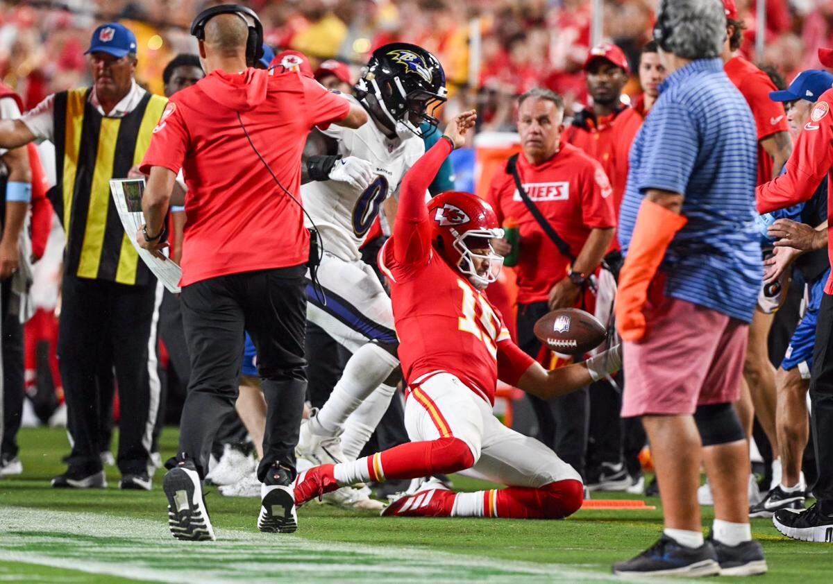 Kansas City Chiefs quarterback Patrick Mahomes (15) is shoved by Baltimore Ravens linebacker Roquan Smith (0) in the second half Thursday, Sept. 5, 2024, at GEHA Field at Arrowhead Stadium.