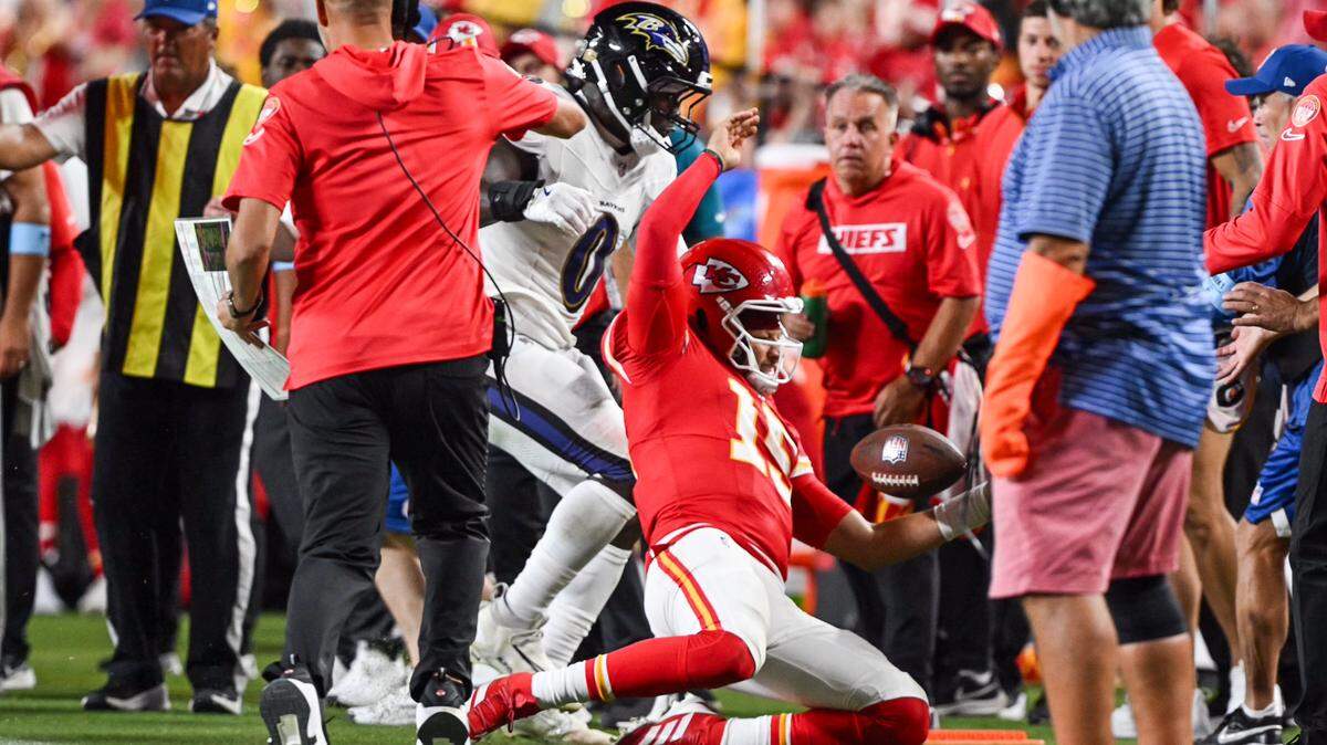 Kansas City Chiefs quarterback Patrick Mahomes (15) is shoved by Baltimore Ravens linebacker Roquan Smith (0) in the second half Thursday, Sept. 5, 2024, at GEHA Field at Arrowhead Stadium.