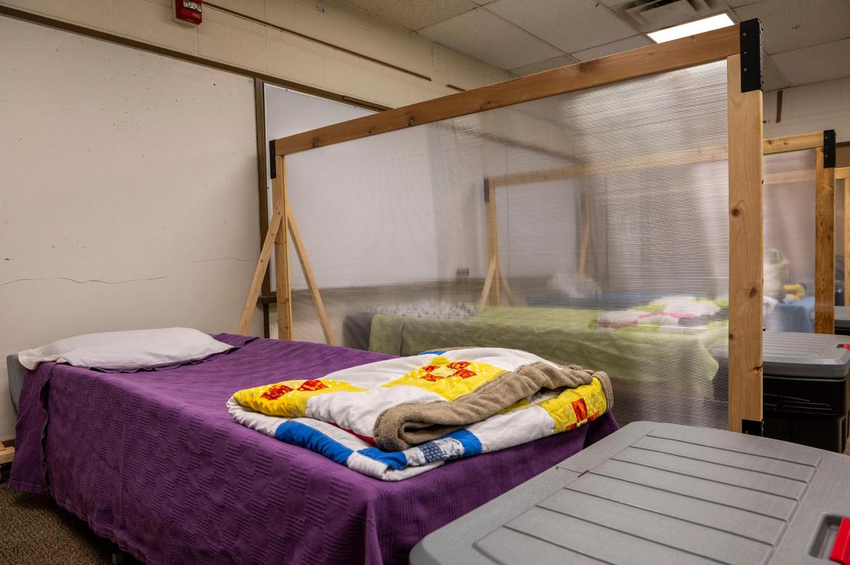 Beds are divided by plexiglass for residents at Project 1020 winter shelter in Lenexa on Wednesday, March 16, 2022.