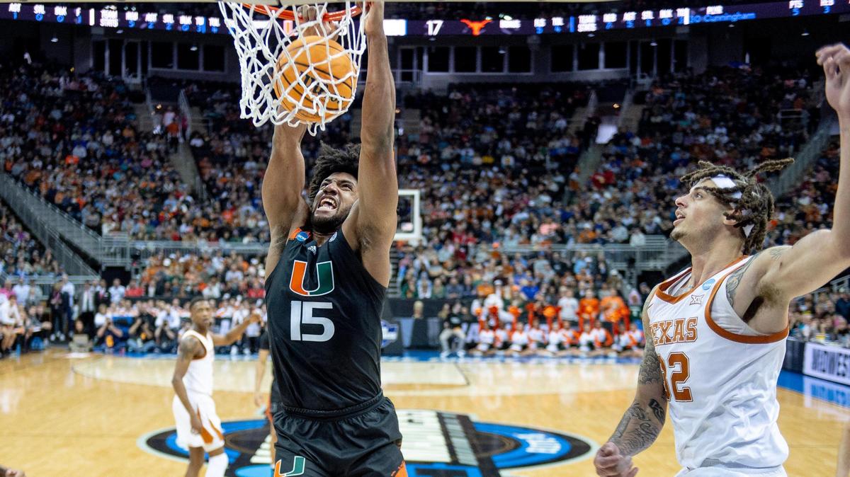 Miami forward Norchad Omier dunks the ball as Texas forward Christian Bishop looks on during an Elite Eight game at the Midwest Regional on Sunday in Kansas City.