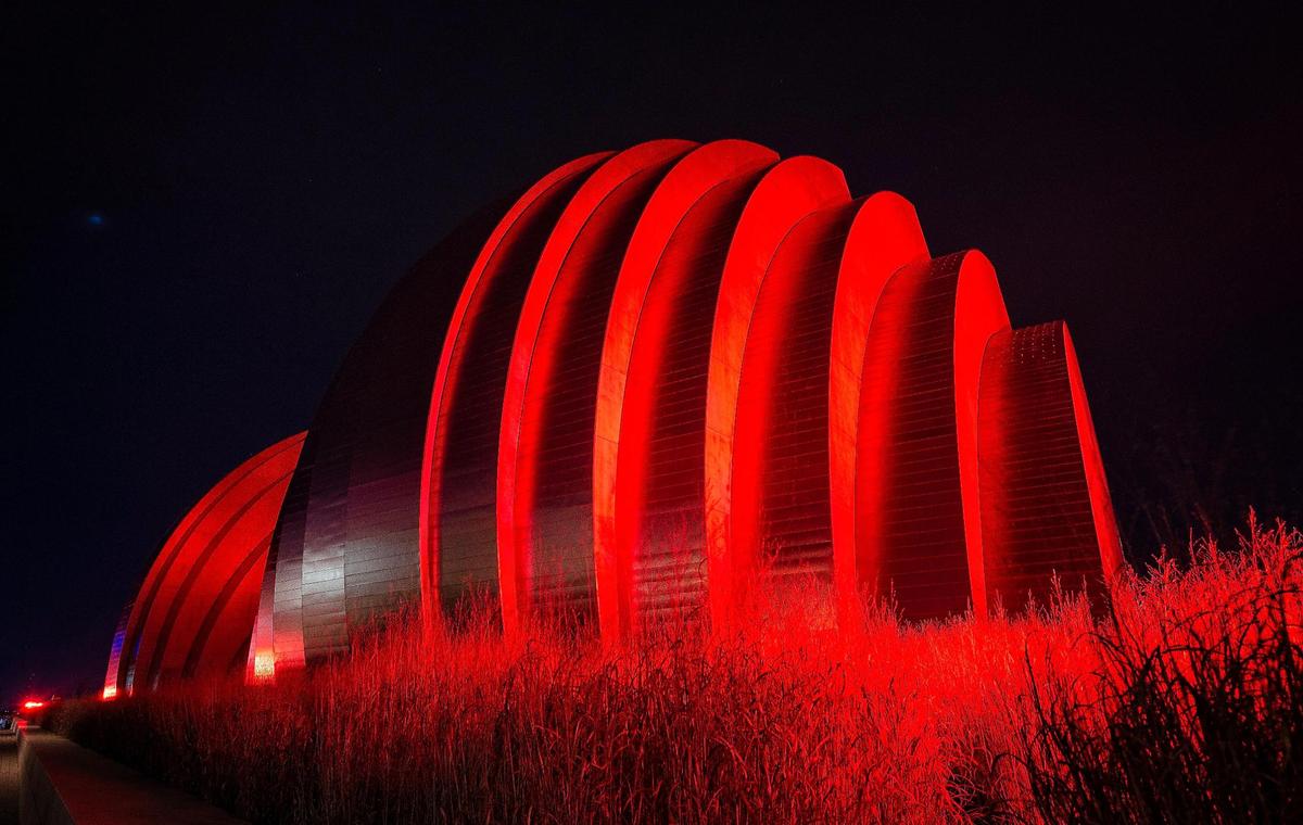 The clamshell side of the Kauffman Center for the Performing Arts glows read in honor of the Kansas City Chiefs.
