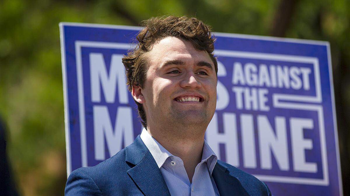 Charlie Kirk, founder of Turning Point USA, smiles during a press conference on the pending lawsuit against the Scottsdale Unified School District announced outside the Arizona Superior Court building in Phoenix on May 5, 2022.
